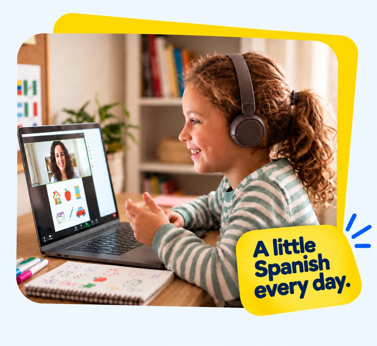 A child enjoying an online Spanish lesson with a teacher on her laptop